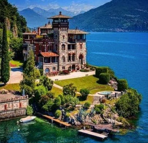 Villa Gaeta on Lake Como, a castellated villa designed by the Coppedè brothers, set on a green promontory over the blue lake
