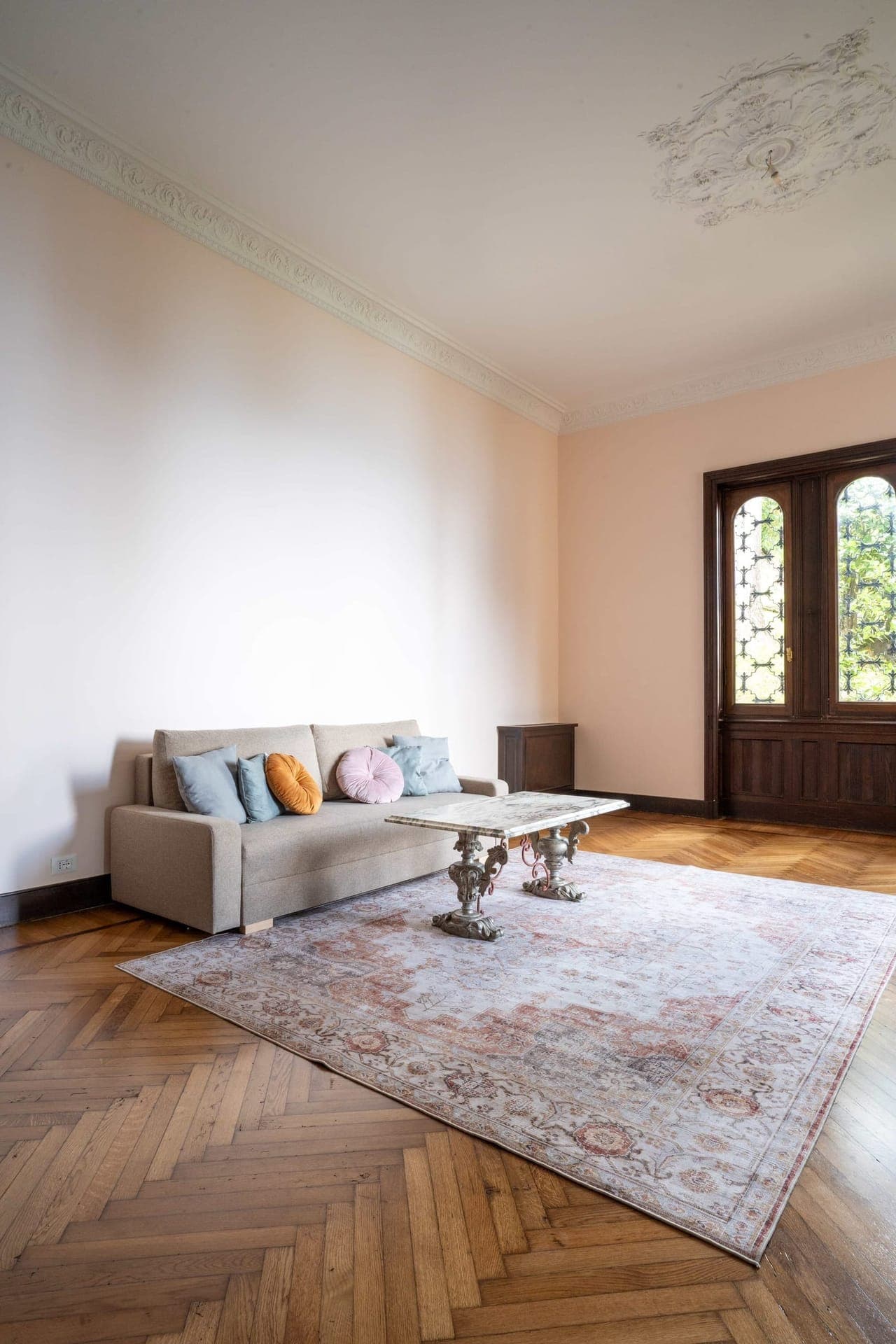 Living room with frescoed ceiling rose and antique marble coffee table